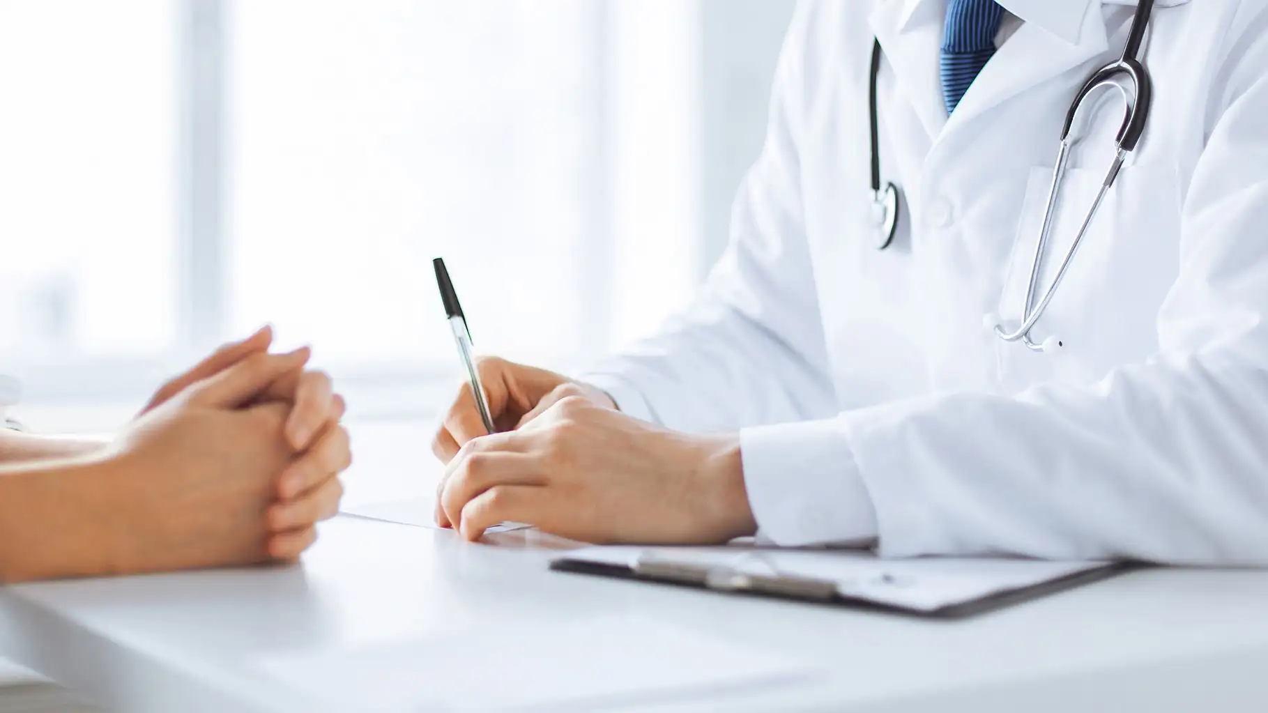 close up of patient and doctor taking notes