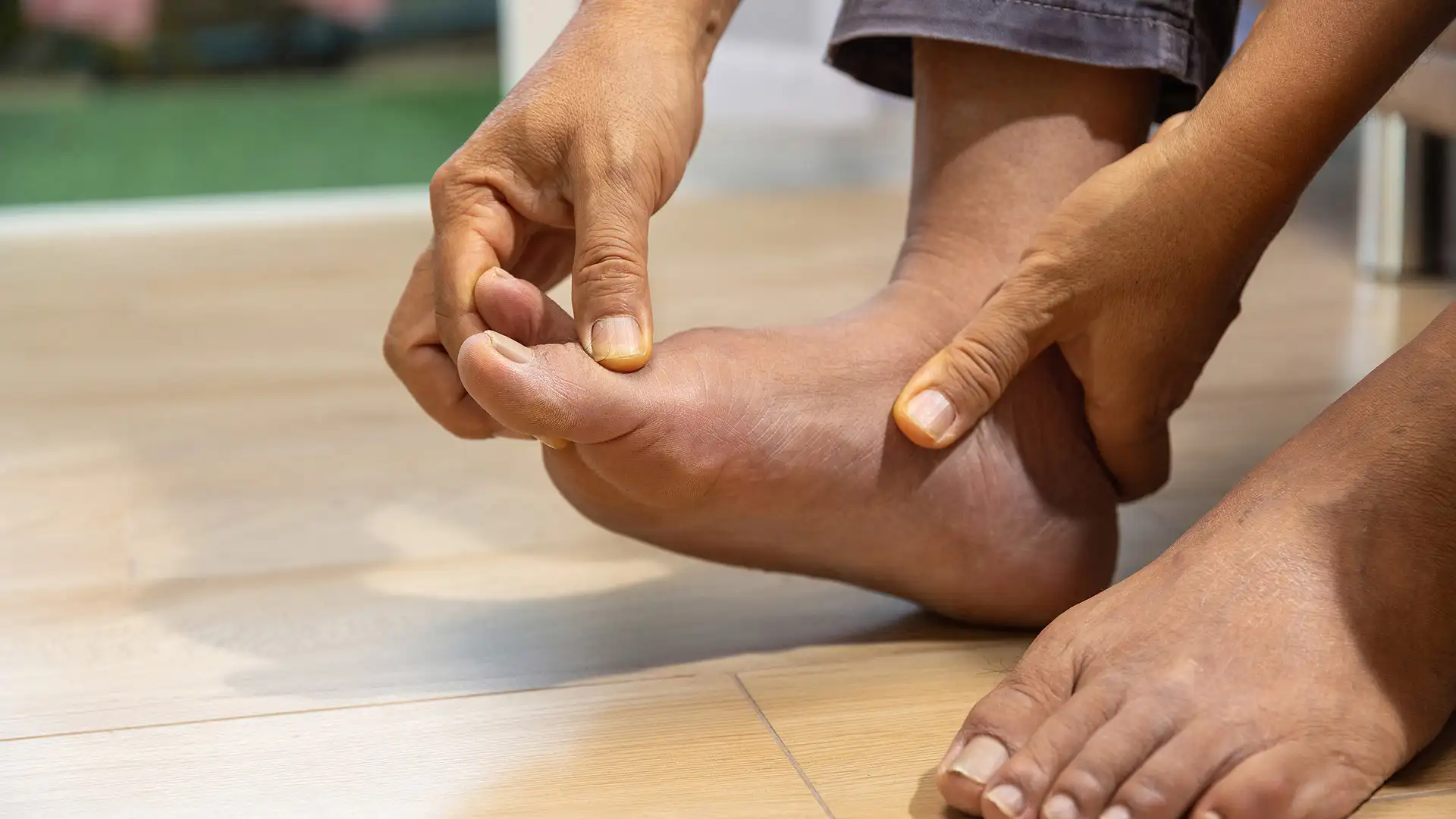Senior man massaging foot with gout pain