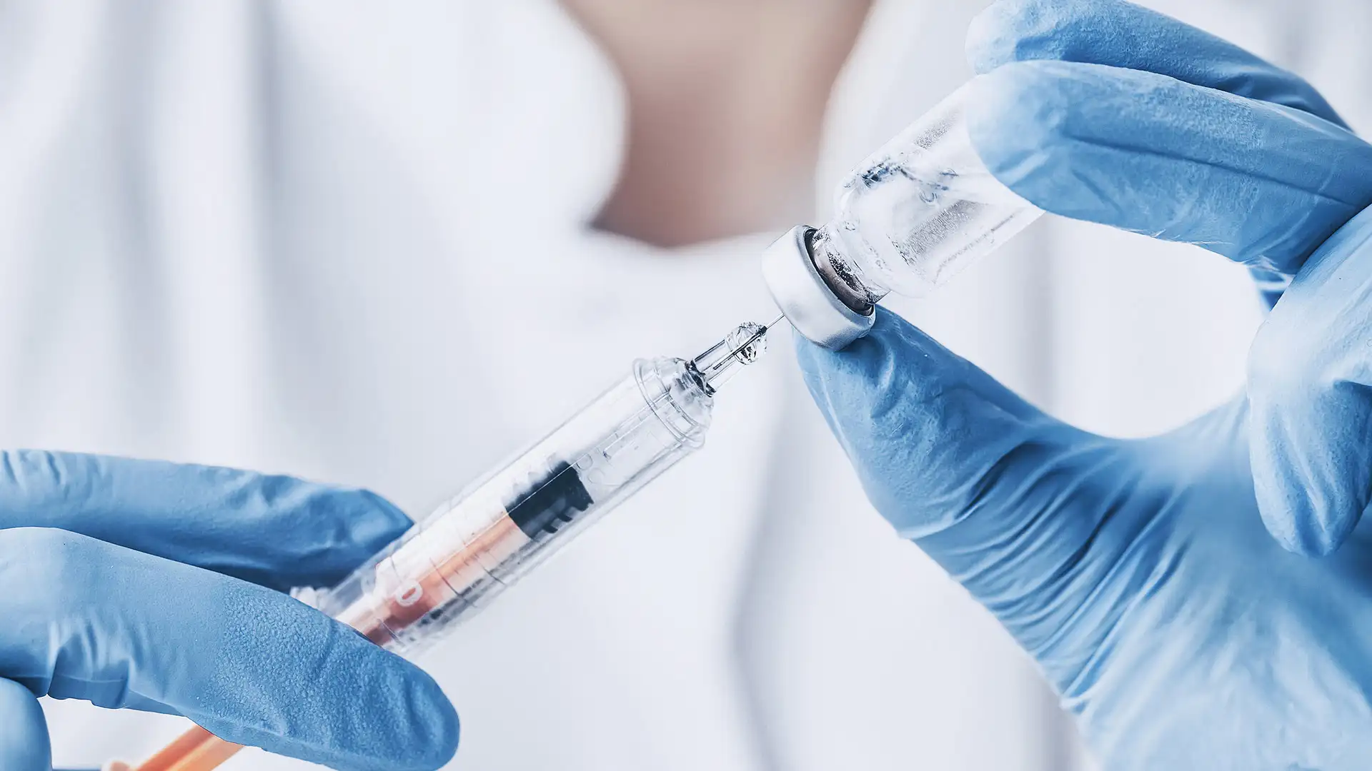 Doctor administering vaccine injection to patient