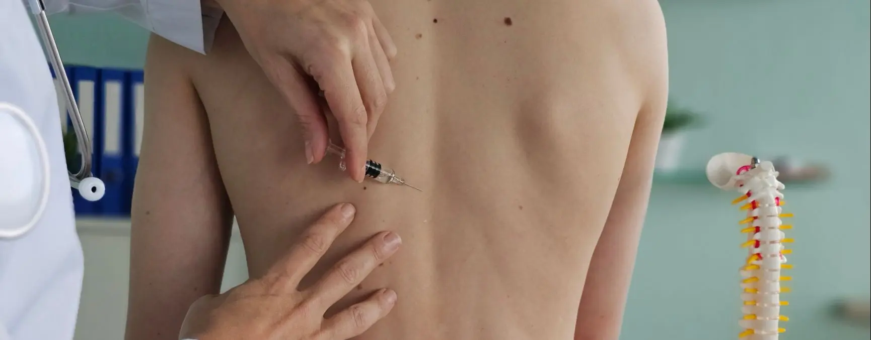 Person at a medical office receiving a thoracic epidural injection.