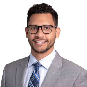 Headshot image of a man in glasses smiling with a suite and tie. This is Dr. Martinez who works at Advanced Pain Medical in California.