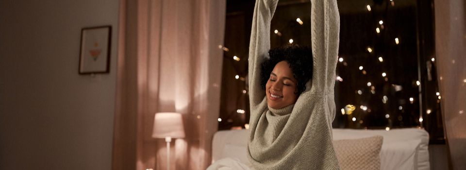 Person stretching their arms over head.