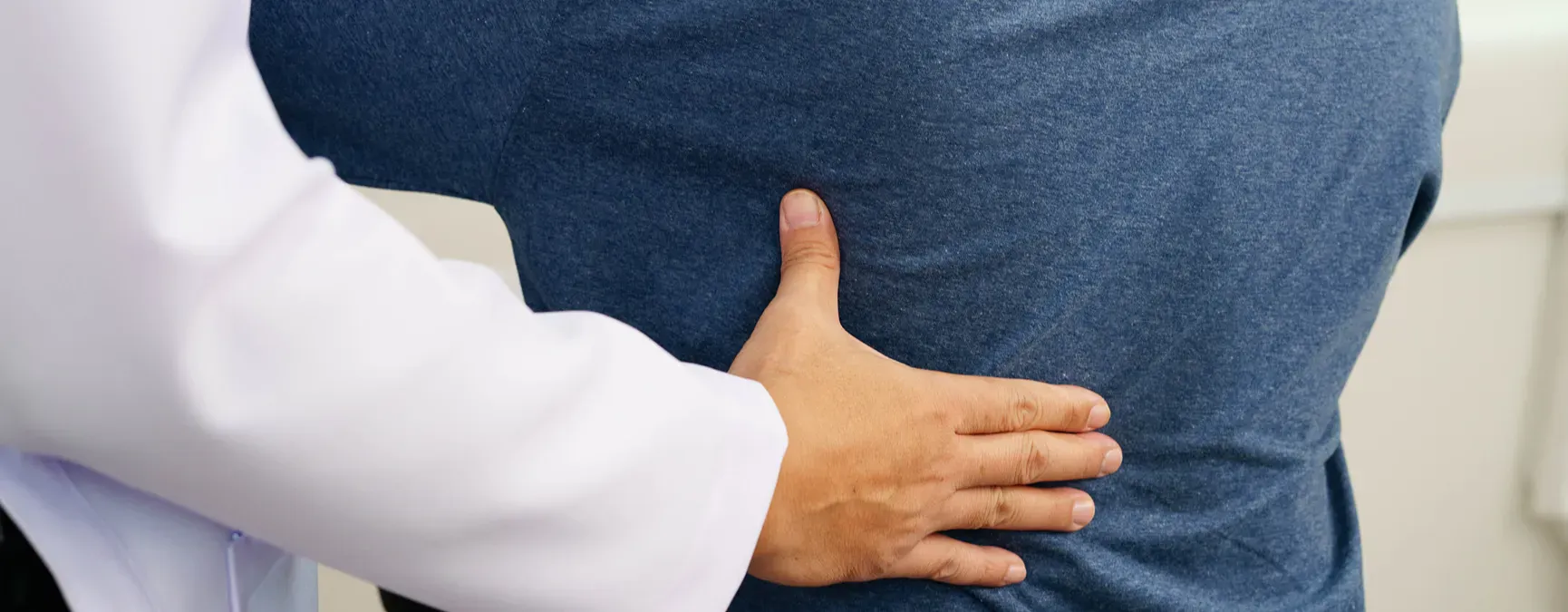 Person at a pain clinic, having their back evaluated.